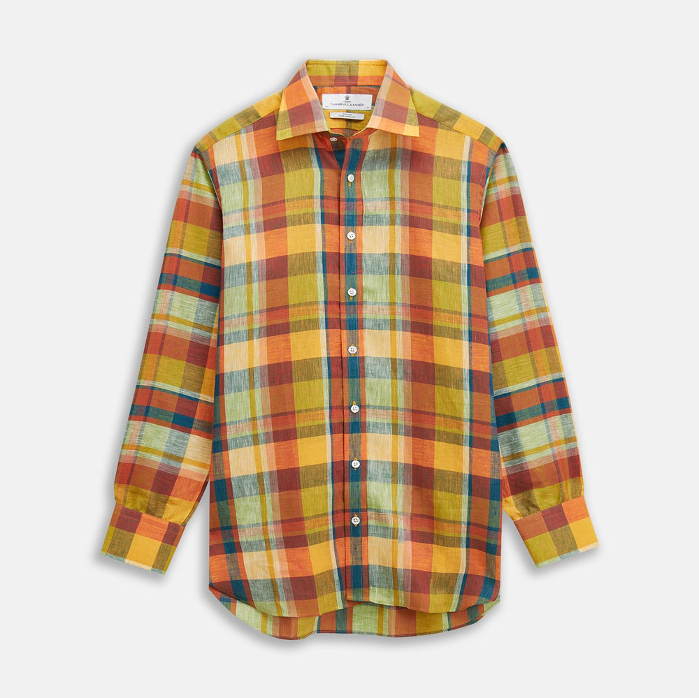 A close-up of Turnbull & Asser’s Orange Madras Check Linen Fabric, showing a vibrant plaid with intersecting red, green, yellow, blue, and orange stripes in a circular frame on a white background.