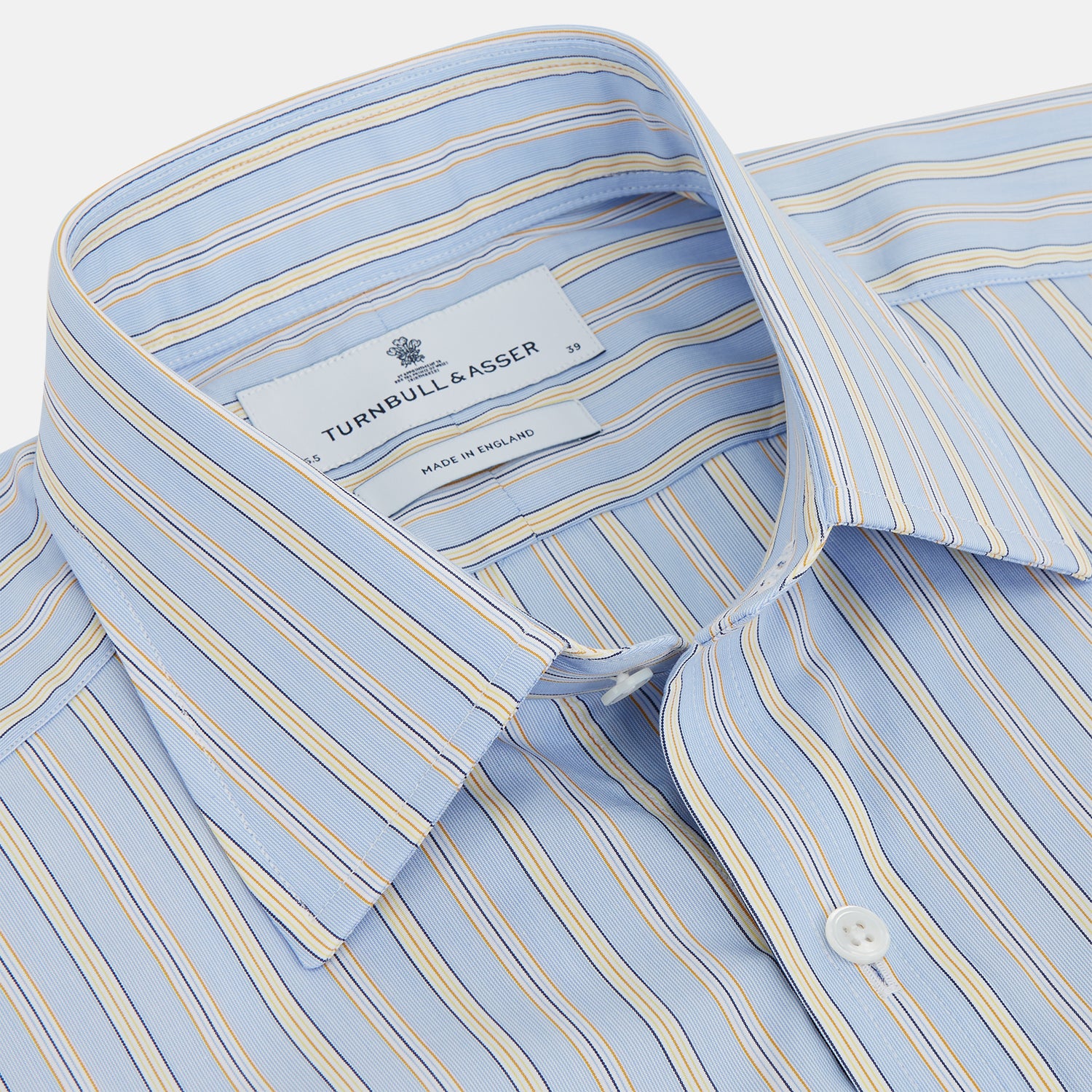 View 2 of product The Turnbull & Asser Blue and Yellow Stripe Poplin Cotton Regular Fit Shirt features a T&A collar, 3-button cuffs, and vertical stripes. It is laid flat on a white background.