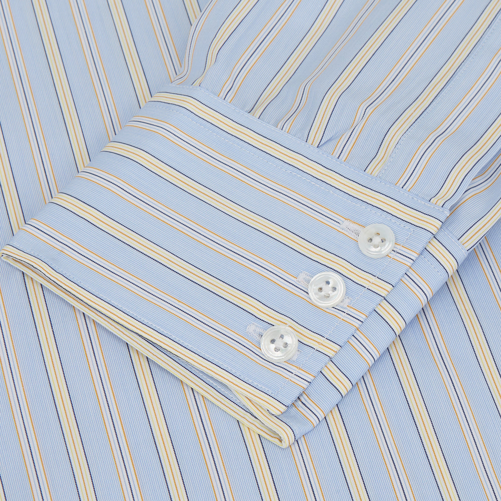 The Turnbull & Asser Blue and Yellow Stripe Poplin Cotton Regular Fit Shirt features a T&A collar, 3-button cuffs, and vertical stripes. It is laid flat on a white background.