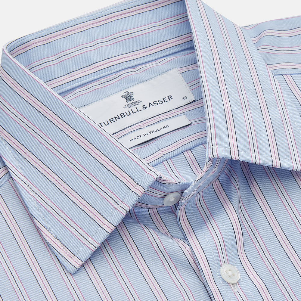 The Turnbull & Asser Blue and Pink Stripe Poplin Cotton Regular Fit Shirt features a T&A collar, 3-button cuffs, and vertical stripes, presented against a plain white background.