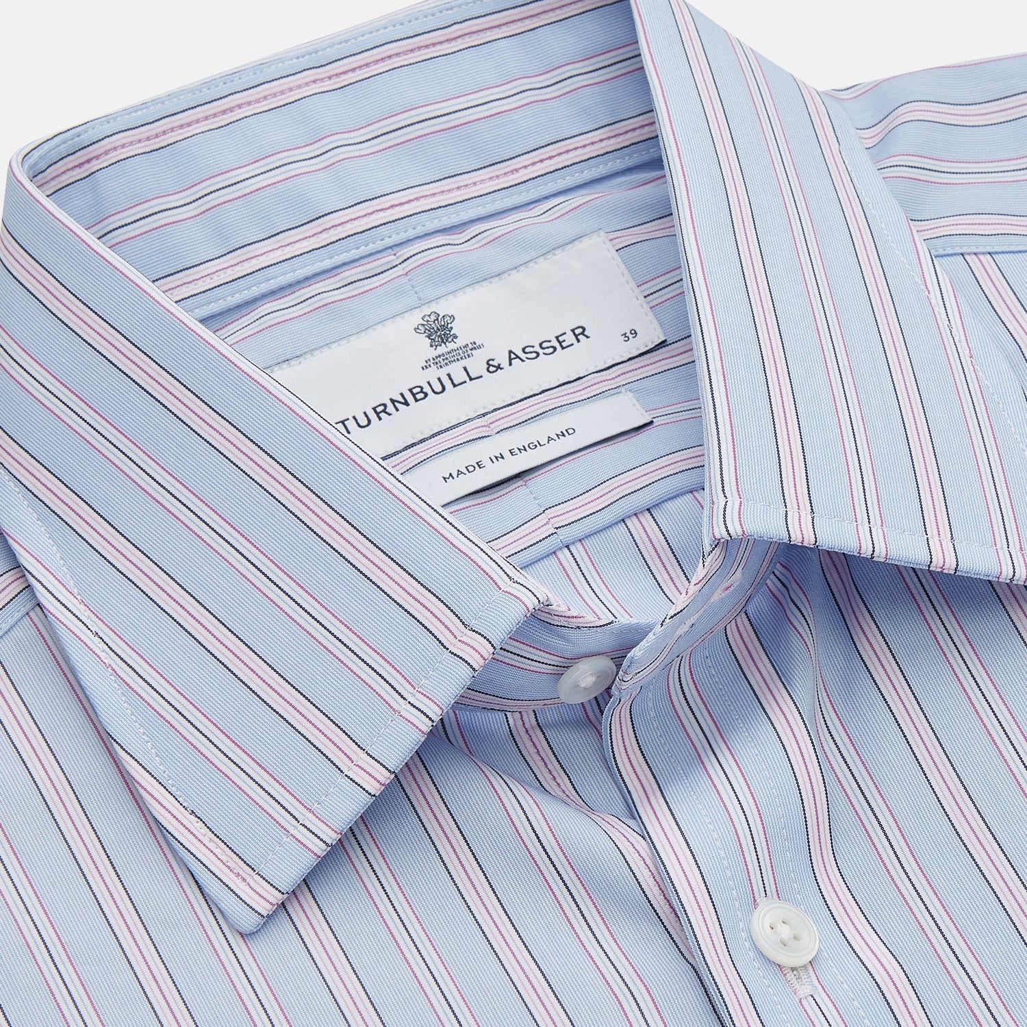 View 2 of product The Turnbull & Asser Blue and Pink Stripe Poplin Cotton Regular Fit Shirt features a T&A collar, 3-button cuffs, and vertical stripes, presented against a plain white background.