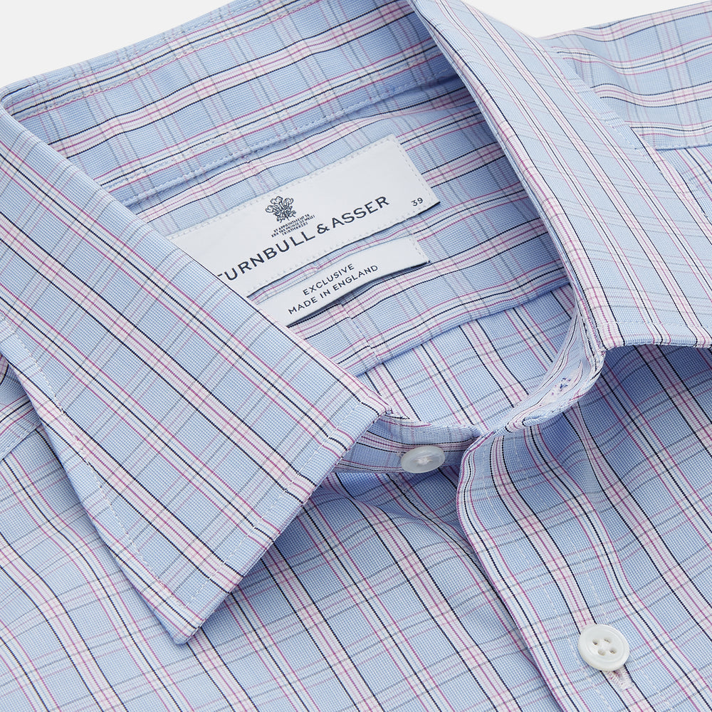 The Turnbull & Asser Blue and Pink Check Poplin Cotton Regular Fit Shirt features a T&A collar, 3-button cuffs, and a blue and pink check pattern, shown laid flat on a white background.