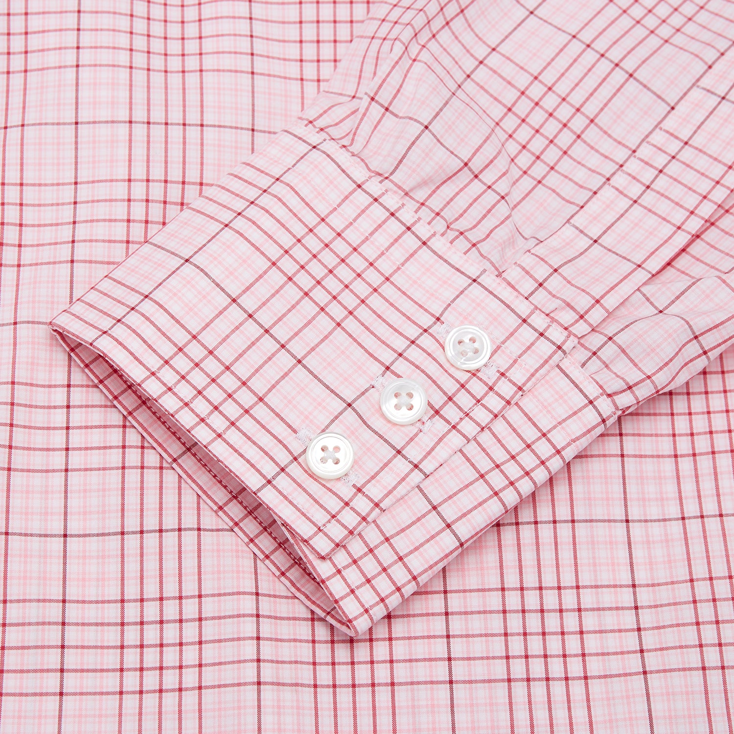 View 3 of product The Turnbull & Asser Pink Fine Check Shirt features superfine cotton Zephir, a T&A collar, and three-button cuffs, shown laid flat on a white background.