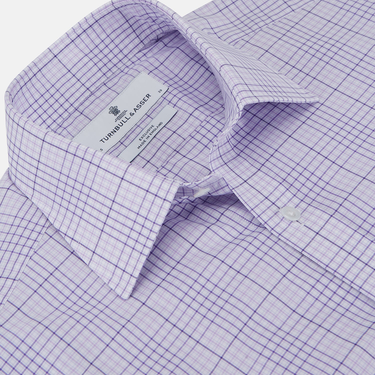 View 2 of product The Turnbull & Asser SHI002-HH3865 shirt features a fine purple check pattern, TA collar, 3 button cuffs, crafted from superfine Zephir cotton. Shown laid flat on a white background.