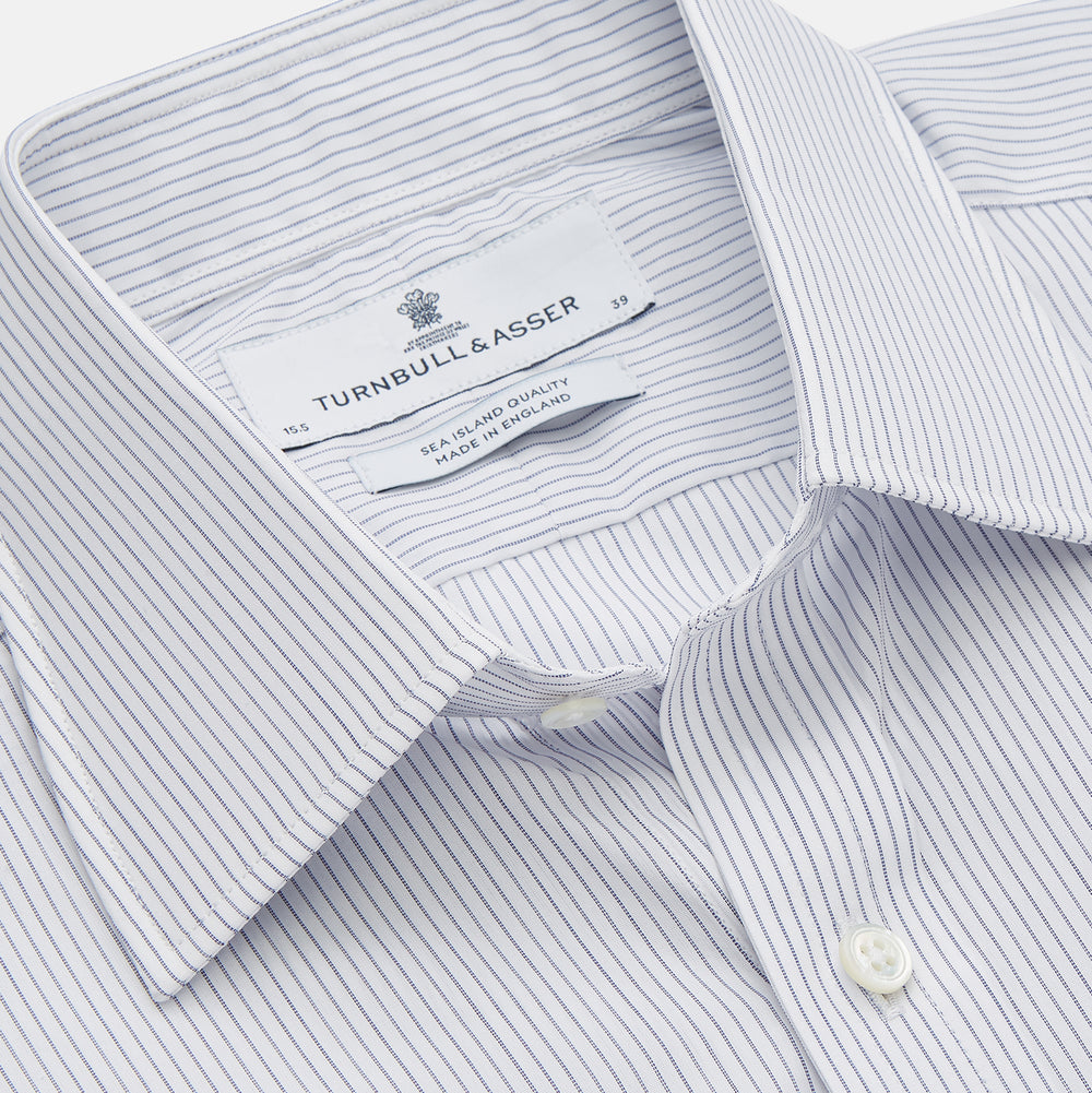 The Turnbull & Asser White and Blue Stripe Sea Island Quality Cotton Shirt features a T&A collar, 3-button cuffs, and fine vertical stripes, displayed on a white background.
