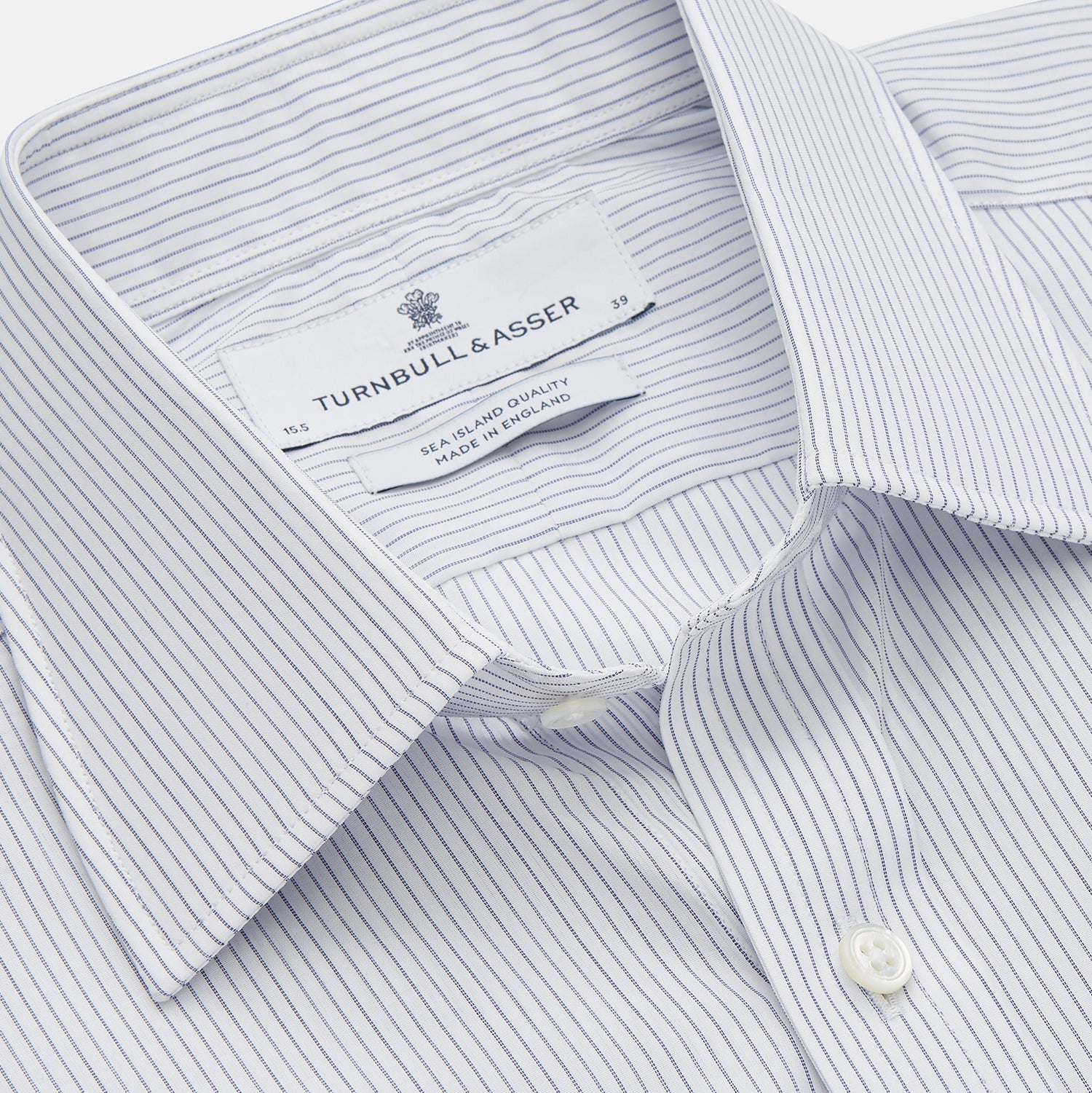 View 2 of product The Turnbull & Asser White and Blue Stripe Sea Island Quality Cotton Shirt features a T&A collar, 3-button cuffs, and fine vertical stripes, displayed on a white background.