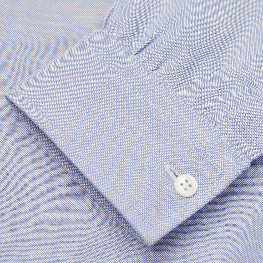 The Turnbull & Asser Blue Chambray Weekend Fit Shirt features a Dorset collar, 1-button cuffs, and white buttons, shown flat on a white background.