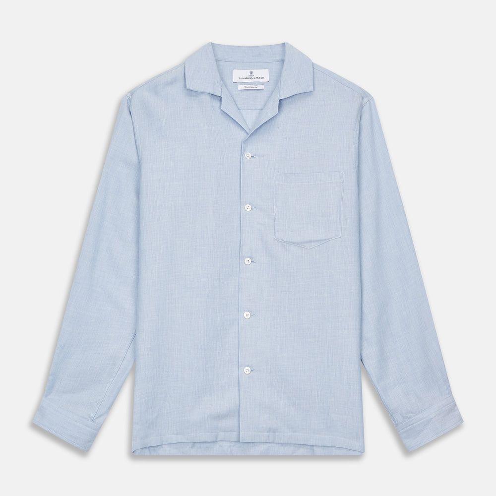The Turnbull & Asser Holiday Fit Blue Cotton and Cashmere Blend Shirt features long sleeves, a classic collar, single chest pocket, and 1-button cuffs with white buttons, shown laid flat on a white background.