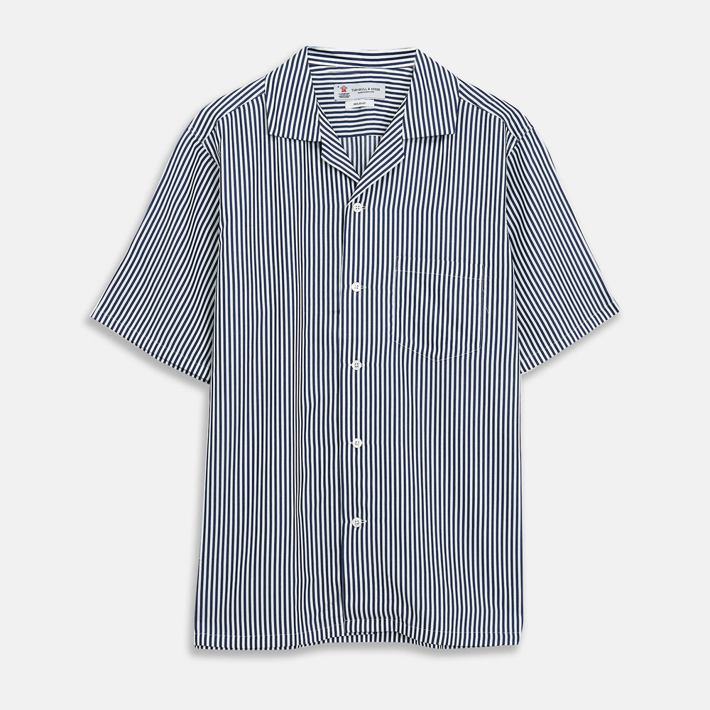 The Turnbull & Asser Navy & White Lyocell Stripe Holiday Fit Shirt is a short-sleeve button-up with a revere collar, vertical navy and white stripes, and a left chest pocket.
