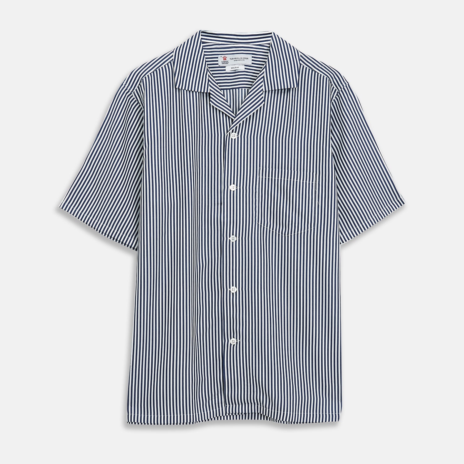 View 1 of product The Turnbull & Asser Navy & White Lyocell Stripe Holiday Fit Shirt is a short-sleeve button-up with a revere collar, vertical navy and white stripes, and a left chest pocket.