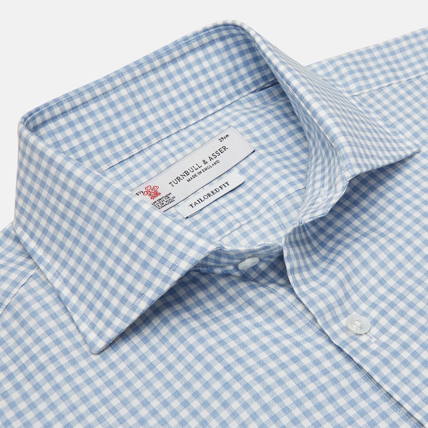 View 3 of product The Turnbull & Asser Tailored Fit Light Blue Gingham Shirt features a Kent collar, 2-button cuffs, and a small blue-and-white checkered pattern, shown on a white background.