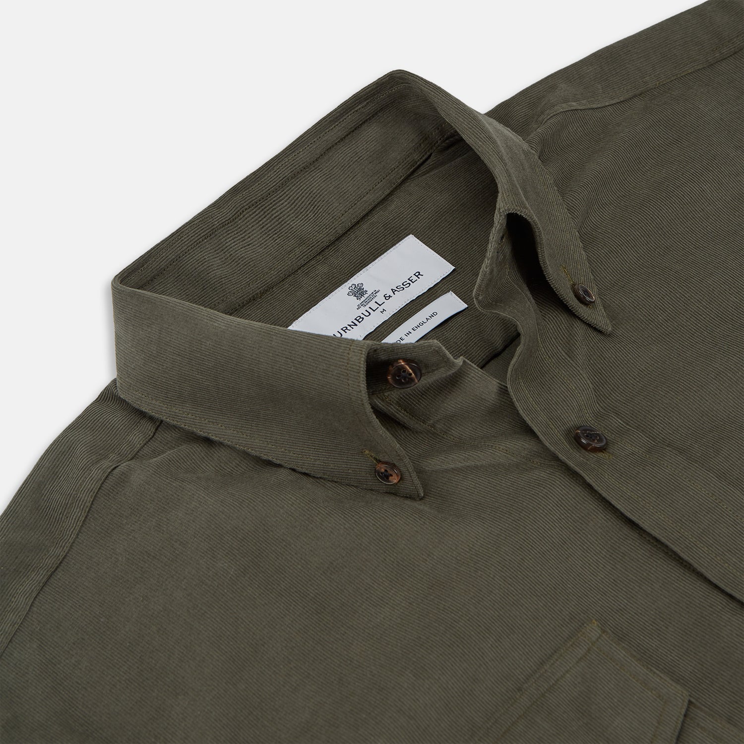 View 2 of product The Turnbull & Asser Khaki Corduroy Officer Weekend Fit Shirt features a Dorset collar, one-button cuffs, and two chest pockets with buttoned flaps, shown laid flat on a white background.