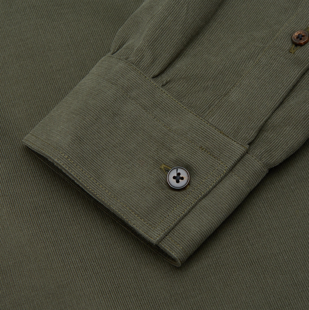 The Turnbull & Asser Khaki Corduroy Officer Weekend Fit Shirt features a Dorset collar, one-button cuffs, and two chest pockets with buttoned flaps, shown laid flat on a white background.