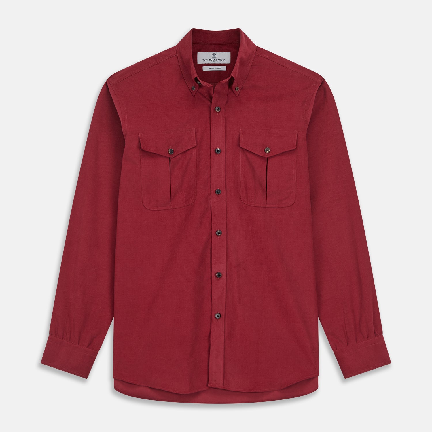 View 1 of product The Turnbull & Asser Burgundy Corduroy Officer Weekend Fit Shirt features a Dorset collar, long sleeves, one-button cuffs, and two chest pockets with buttoned flaps, shown laid flat on a white background.