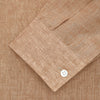 View 2 of product The Brown Linen Officer Weekend Fit Shirt by Turnbull & Asser features a Dorset collar, 1-button cuffs, two chest pockets, and white buttons; shown here laid flat on a white background.