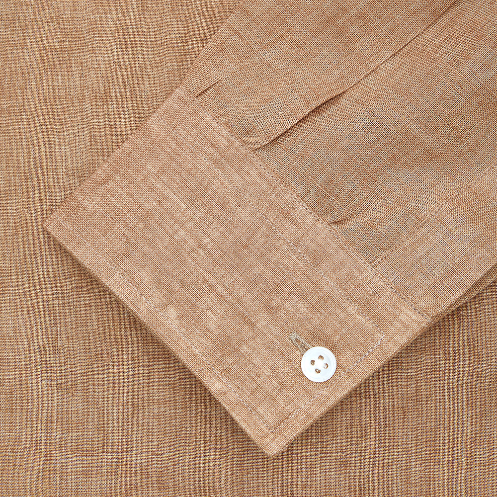 The Brown Linen Officer Weekend Fit Shirt by Turnbull & Asser features a Dorset collar, 1-button cuffs, two chest pockets, and white buttons; shown here laid flat on a white background.