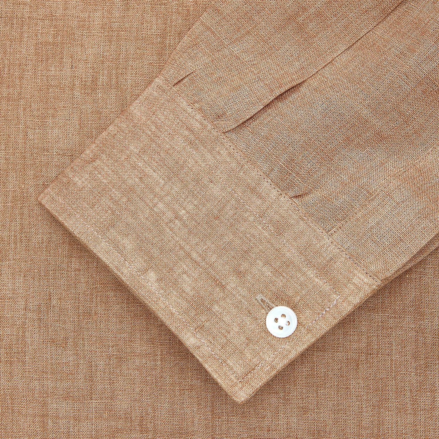 View 2 of product The Brown Linen Officer Weekend Fit Shirt by Turnbull & Asser features a Dorset collar, 1-button cuffs, two chest pockets, and white buttons; shown here laid flat on a white background.