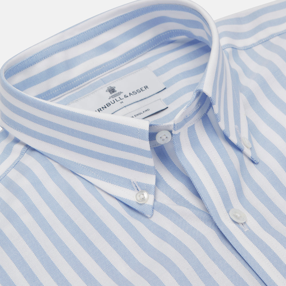 The Turnbull & Asser Blue and White Bengal Stripe Oxford Weekend Fit Shirt features a Dorset collar and 1-button cuffs, shown laid flat on a white background.
