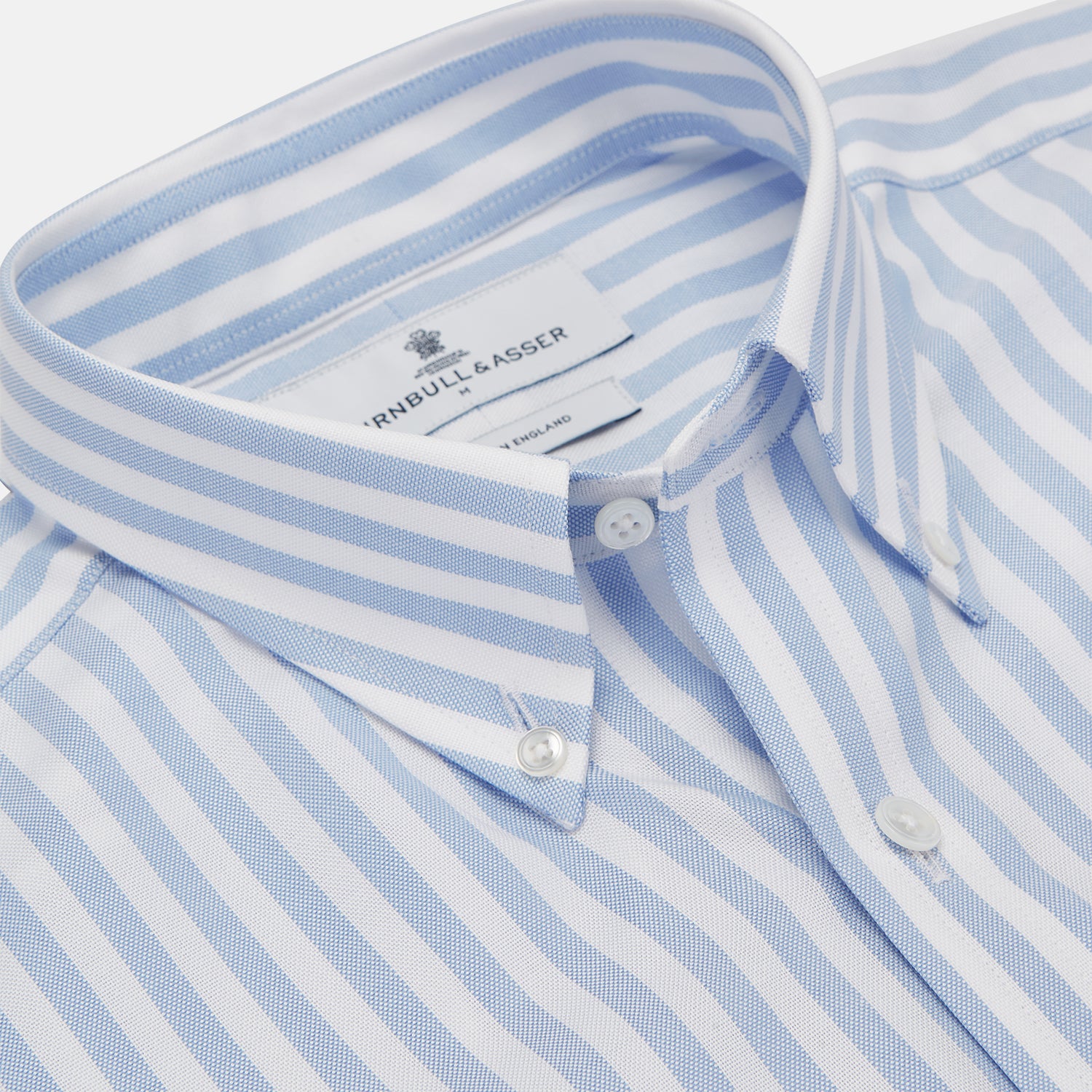 View 2 of product The Turnbull & Asser Blue and White Bengal Stripe Oxford Weekend Fit Shirt features a Dorset collar and 1-button cuffs, shown laid flat on a white background.