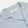 View 6 of product The Turnbull & Asser Holiday Fit Blue Cotton and Cashmere Blend Shirt features long sleeves, a classic collar, single chest pocket, and 1-button cuffs with white buttons, shown laid flat on a white background.