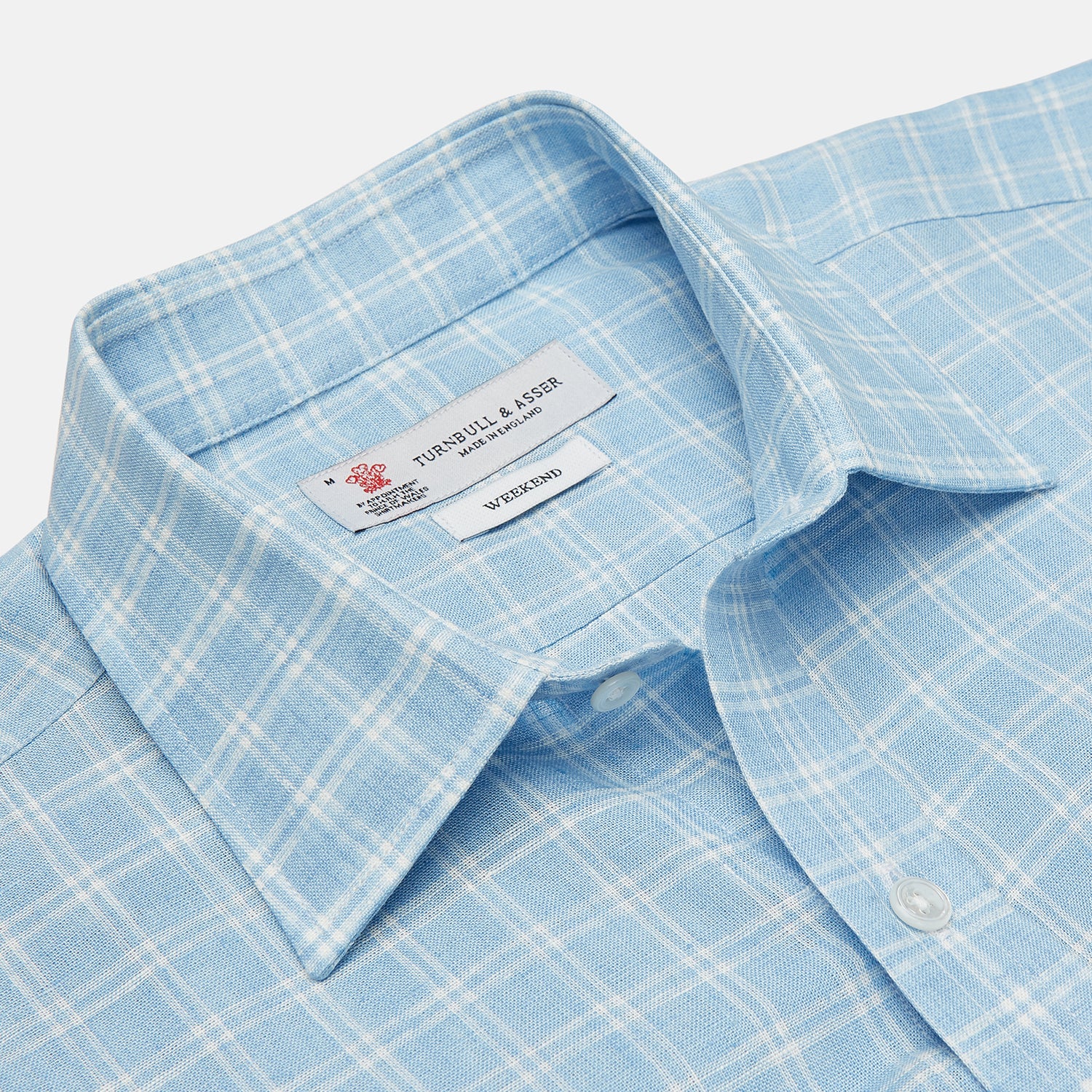 View 3 of product The Turnbull & Asser Weekend Fit Blue Plaid Linen Shirt features a white check pattern, Derby collar, long sleeves with 1-button cuffs, single chest pocket, and button-up front, shown against a white background.