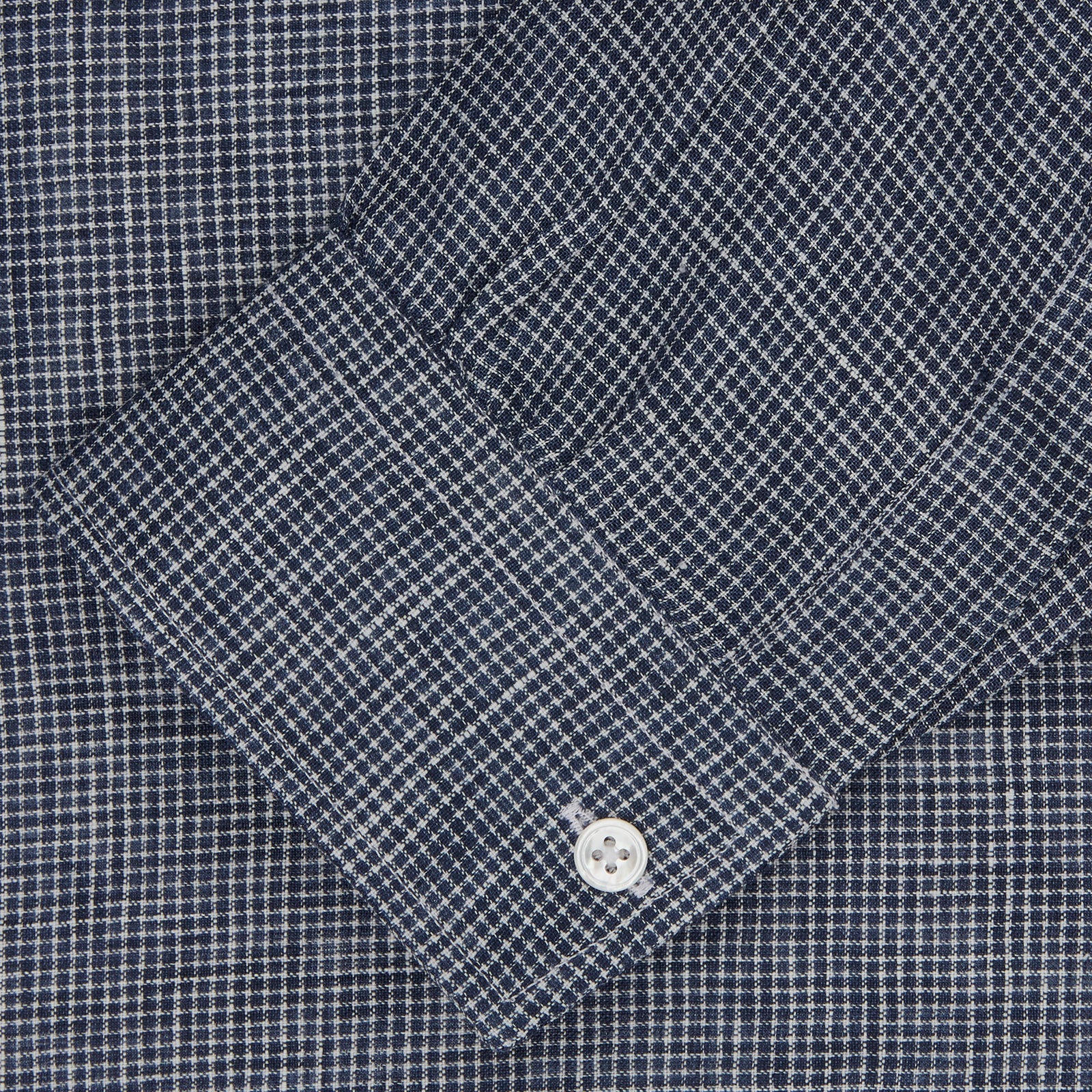 View 2 of product The Turnbull & Asser Weekend Fit Navy Check Linen Shirt features a Derby collar, left chest pocket, 1-button cuffs, and white buttons in textured microcheck fabric, shown laid flat on a white background.