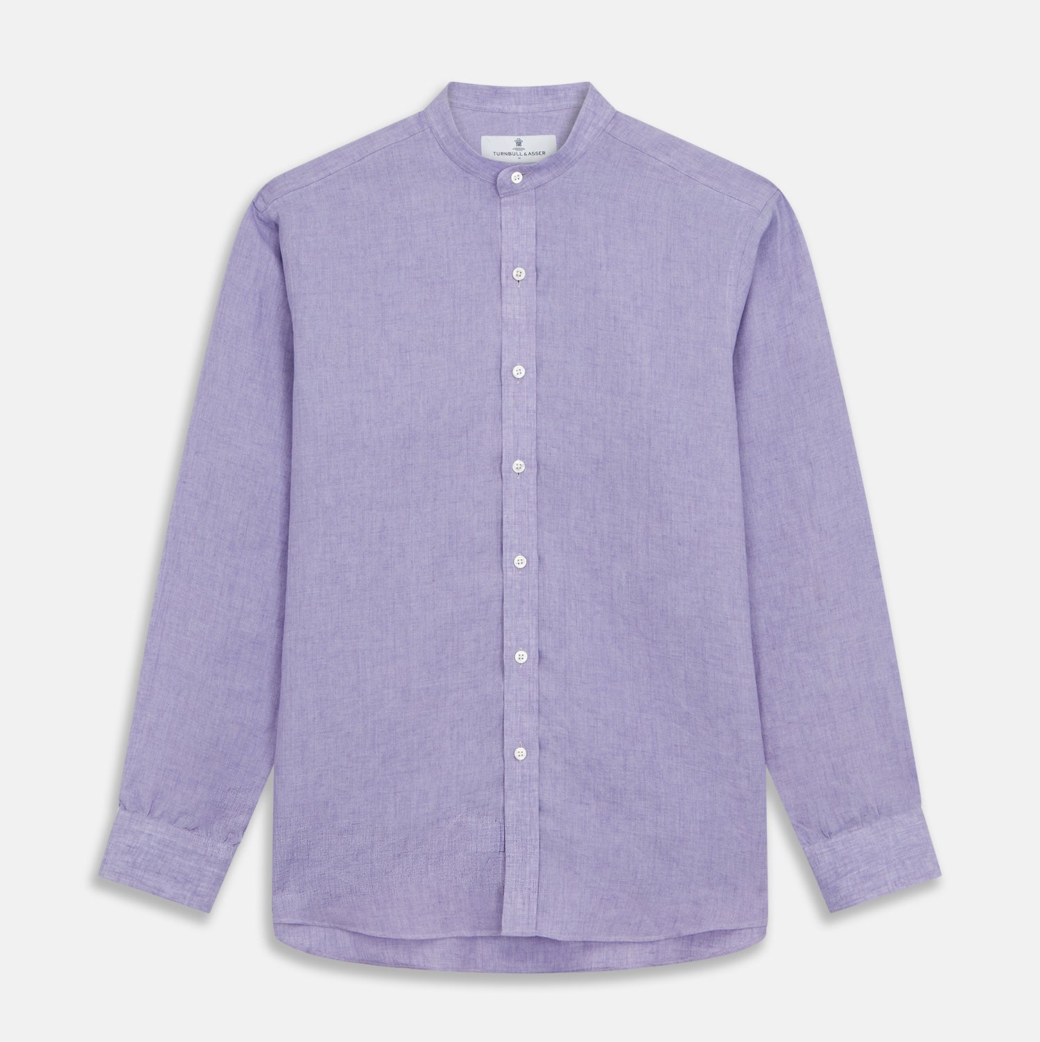 View 3 of product A man stands against a beige background wearing the Turnbull & Asser Lilac Weekend Fit Linen Blake Shirt with Stand Collar and 1-Button Cuffs, paired with dark pinstriped pants and brown sandals—a relaxed weekend look.
