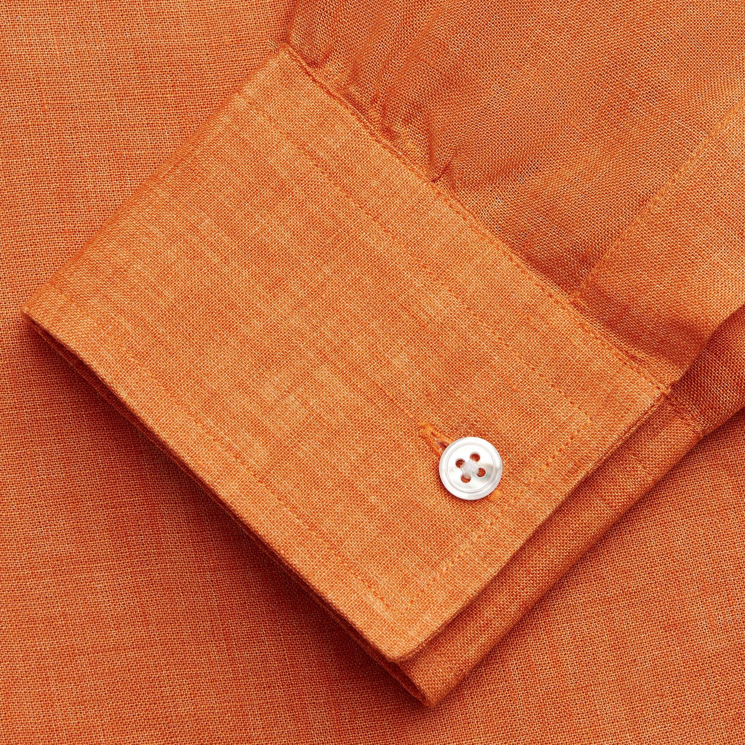 View 5 of product The Turnbull & Asser Orange Weekend Fit Linen Nevis Shirt features a Derby collar, long sleeves with 1-button cuffs, white buttons, and a chest pocket, shown flat against a white background.