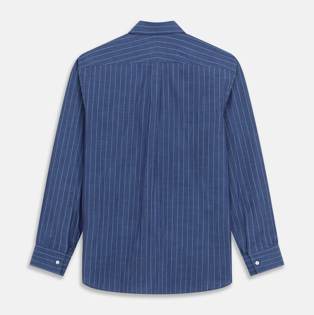 Close-up of a person wearing the Turnbull & Asser Blue Stripe Weekend Fit Nevis Shirt with Derby Collar and 1-Button Cuffs under a dark pinstripe blazer, focusing on the collar and upper chest. The face is partially out of frame.