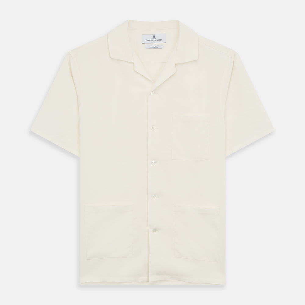 The Turnbull & Asser Cream Holiday Fit Silk Phillips Shirt features a revere collar, short sleeves, and three front pockets, shown flat on a white background.