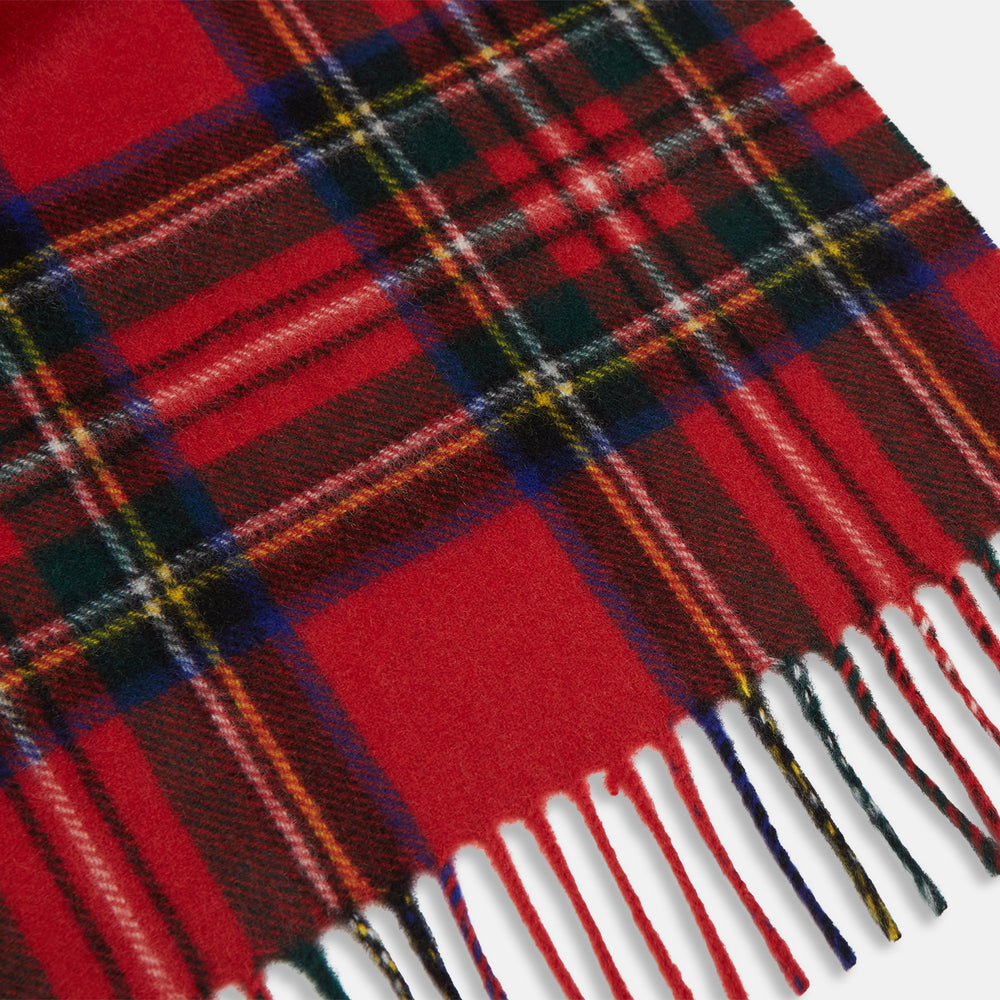 The Turnbull & Asser Royal Stewart Tartan Cashmere Scarf, showcasing a classic red plaid with black, yellow, and green accents and fringed ends, is displayed against a white background.