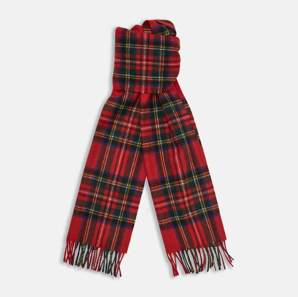 The Turnbull & Asser Royal Stewart Tartan Cashmere Scarf, showcasing a classic red plaid with black, yellow, and green accents and fringed ends, is displayed against a white background.