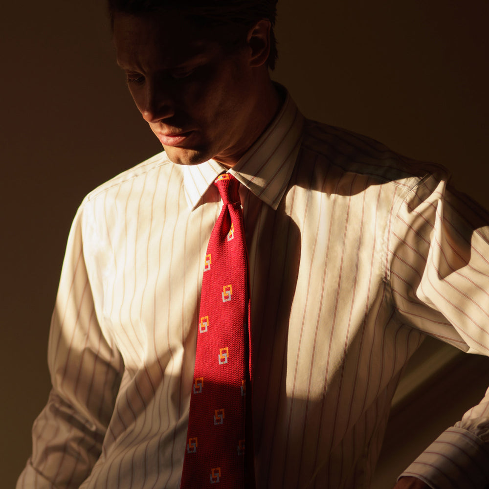 The Turnbull & Asser Red and Blue Multi-stripe Cotton Regular Fit Mayfair Shirt features a button-down front and classic collar, displayed on a plain white background.
