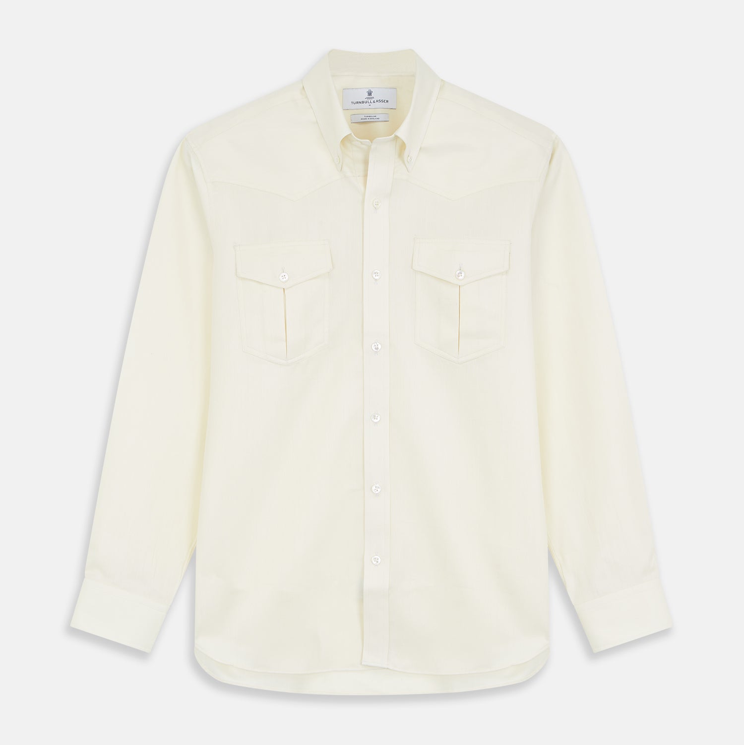 View 1 of product The Turnbull & Asser Cream Weekend Fit Larkin Shirt features a Dorset collar, 3-button cuffs, and two button-flap chest pockets in soft herringbone cotton, displayed flat on a white background.