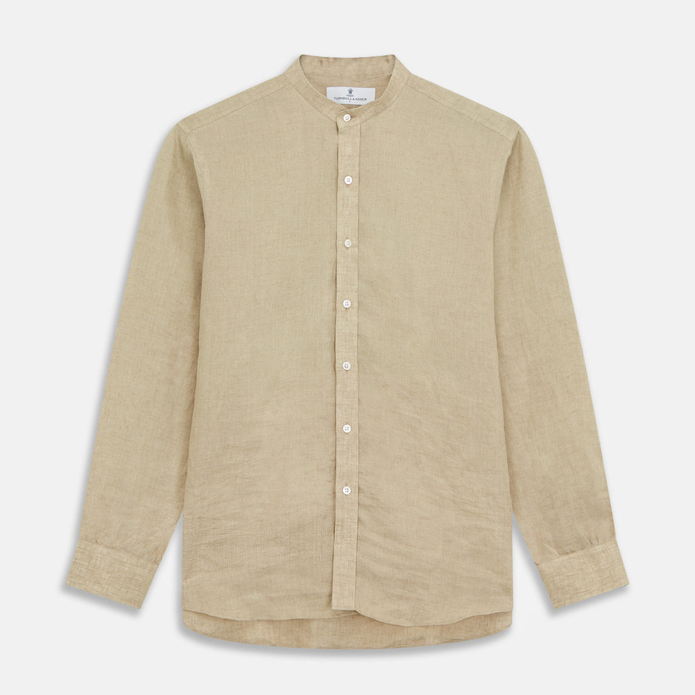 A man with a bald head and trimmed beard wears the Turnbull & Asser Beige Weekend Fit Linen Blake Shirt with stand collar and 1-button cuffs, standing calmly against a matching beige background.