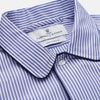 View 2 of product The Turnbull & Asser Blue Bengal Stripe Piped Cotton Nightshirt features long sleeves, a pointed collar, dark-trimmed pocket, curved hem, button details, and cuffed sleeves for an elegant look.