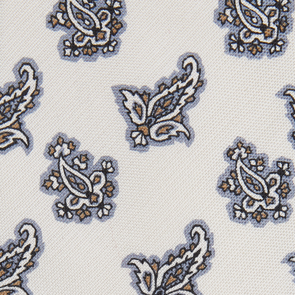The Ecru Paisley Floral Cotton Silk Blend Tie by Turnbull & Asser features a paisley floral pattern, elegantly displayed and neatly rolled on a plain white background.