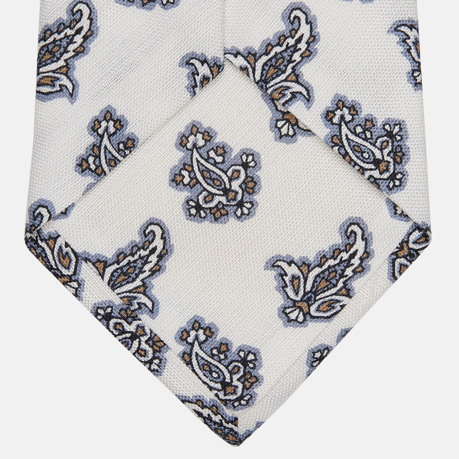 View 4 of product The Ecru Paisley Floral Cotton Silk Blend Tie by Turnbull & Asser features a paisley floral pattern, elegantly displayed and neatly rolled on a plain white background.