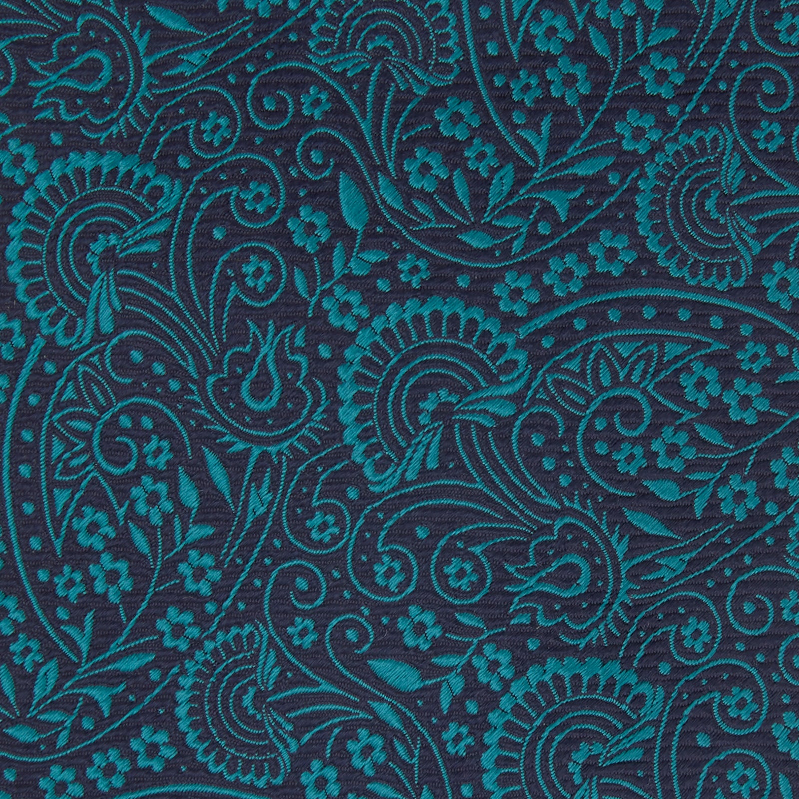 View 4 of product The Turnbull & Asser Green and Navy Tonal Paisley Silk Tie is an elegant men's accessory, featuring a rolled-up design with an intricate paisley pattern, shown on a white background.