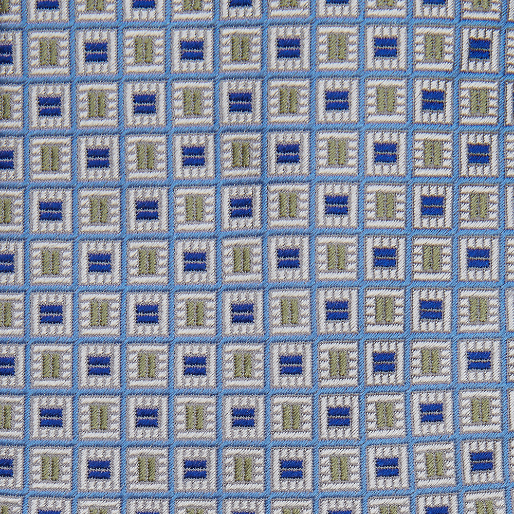 A Turnbull & Asser Blue and Yellow Geometric Silk Jacquard Tie is shown rolled up on a plain light background.