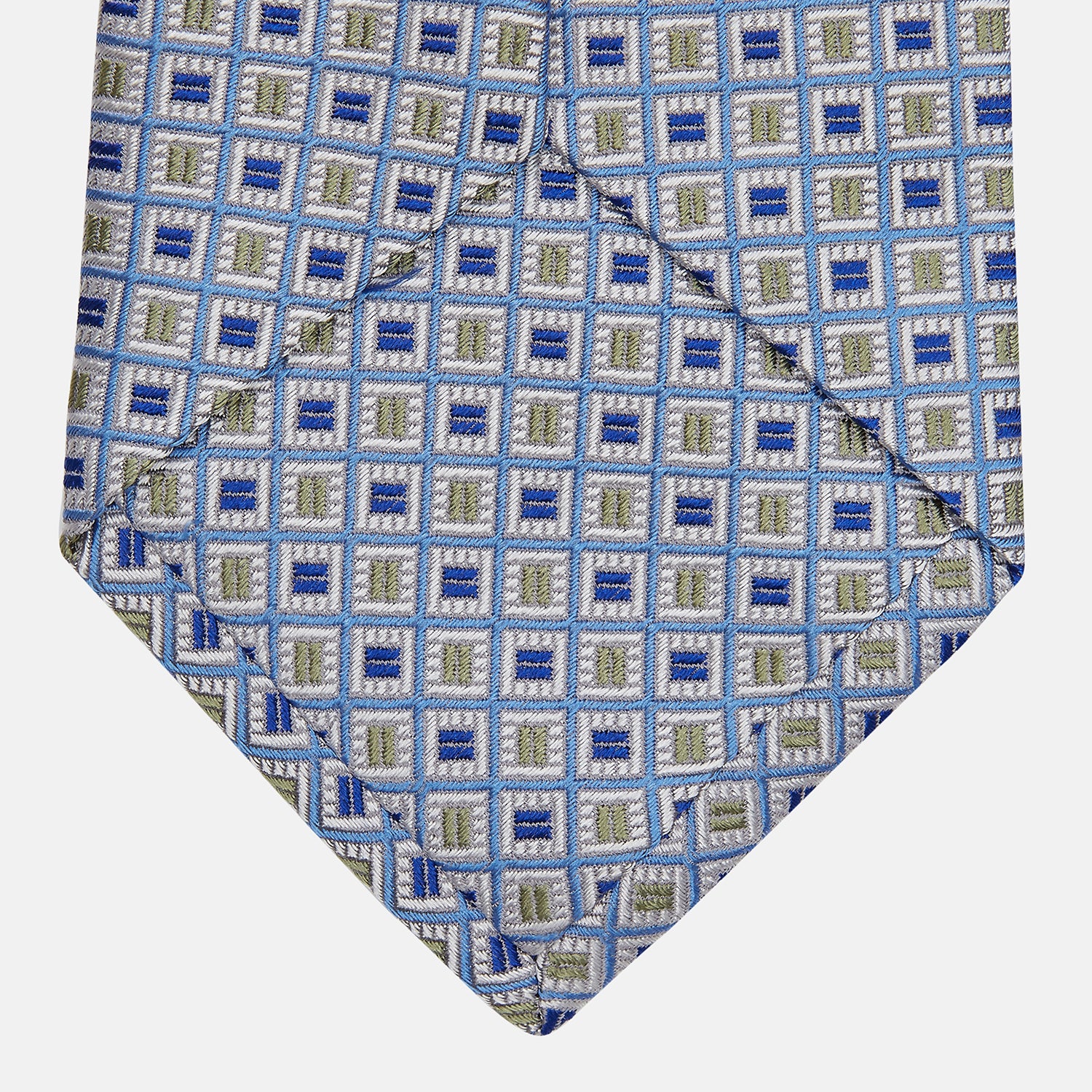 View 3 of product A Turnbull & Asser Blue and Yellow Geometric Silk Jacquard Tie is shown rolled up on a plain light background.