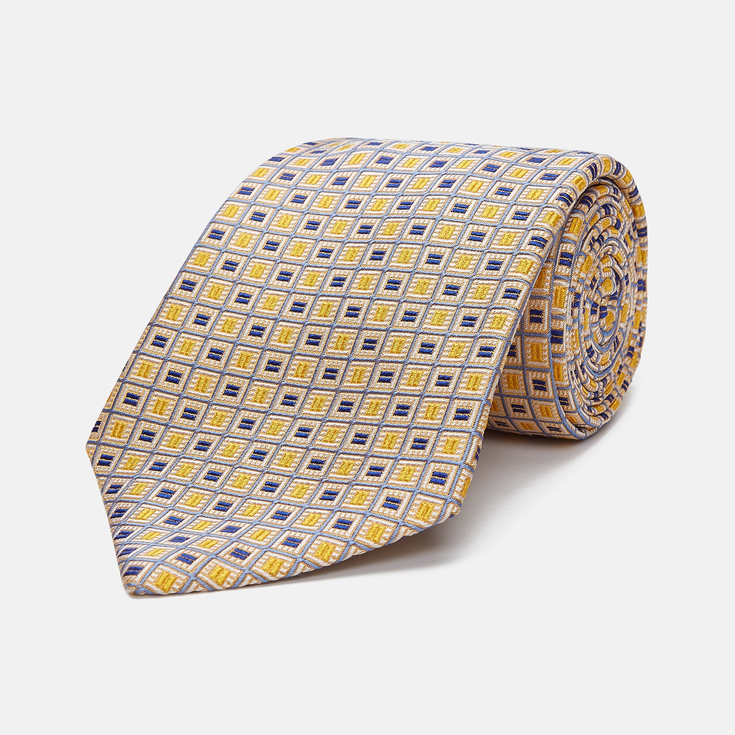 View 1 of product The Turnbull & Asser Yellow and Navy Geometric Silk Jacquard Tie features a striking square pattern on a light background, ideal for formal occasions, shown rolled up against a plain white surface.