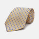The Turnbull & Asser Yellow and Navy Geometric Silk Jacquard Tie features a striking square pattern on a light background, ideal for formal occasions, shown rolled up against a plain white surface.