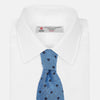 View 4 of product The Turnbull & Asser Dark Blue Fine Square Slub Silk Tie, featuring an elegant square pattern and subtle texture, is shown rolled-up against a plain white background.