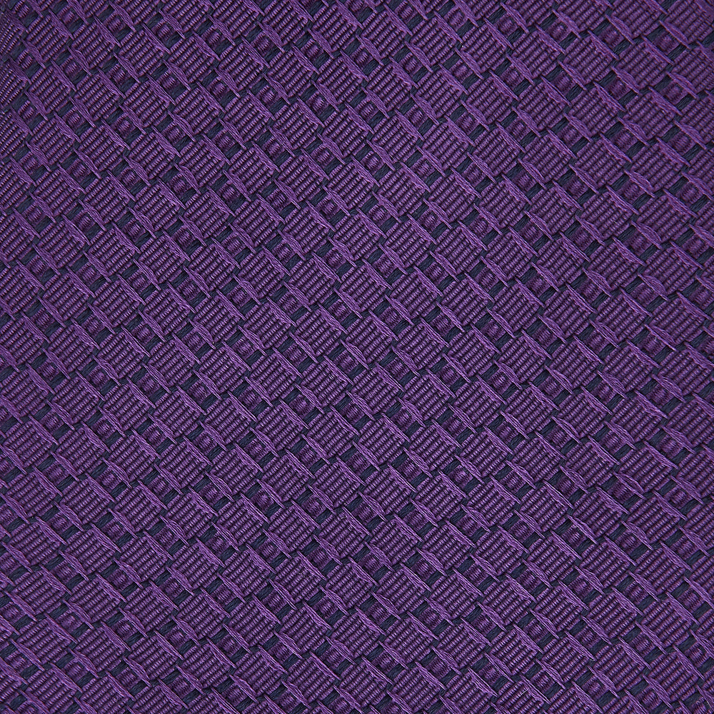 The Turnbull & Asser Purple Abstract Tonal Silk Jacquard Tie, featuring a textured geometric pattern, is shown rolled up against a white background—an ideal choice to elevate any formal outfit.