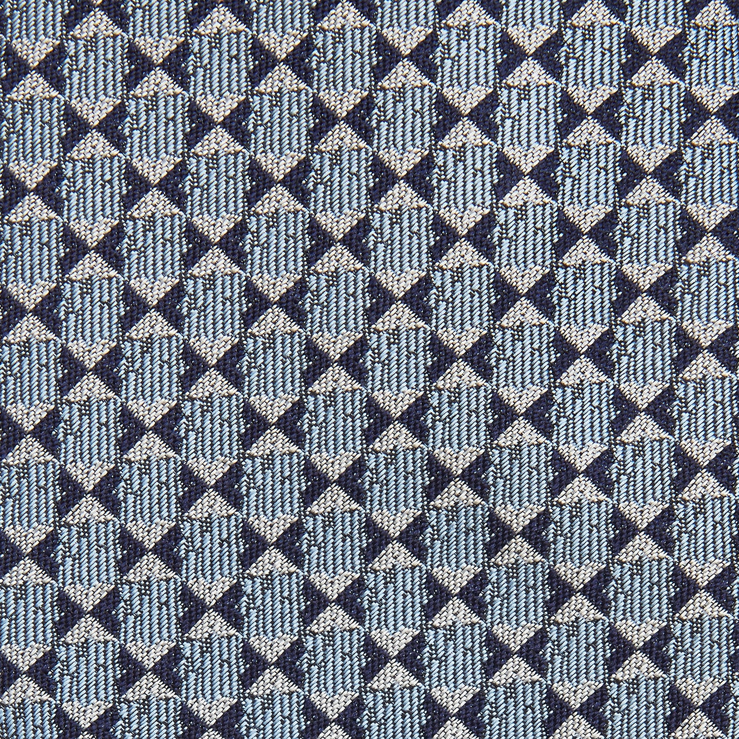 View 2 of product The Chambray Blue Graphic Floral Silk Jacquard Tie by Turnbull & Asser features a modern floral pattern in silk, shown rolled up against a plain white background.