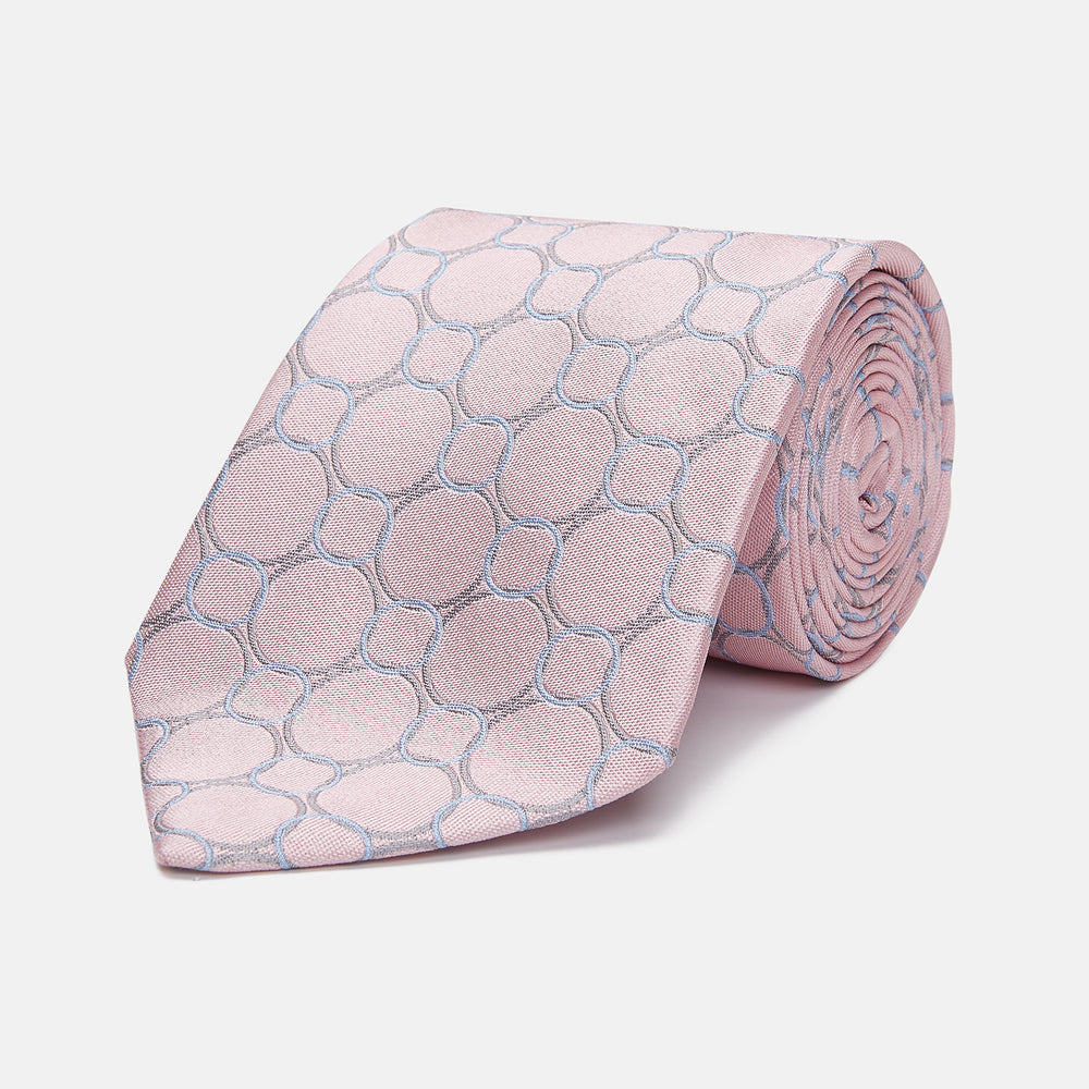 The Turnbull & Asser Baby Pink and Blue Circle Jacquard Silk Tie features a subtle geometric pattern, elegantly rolled against a plain white background.