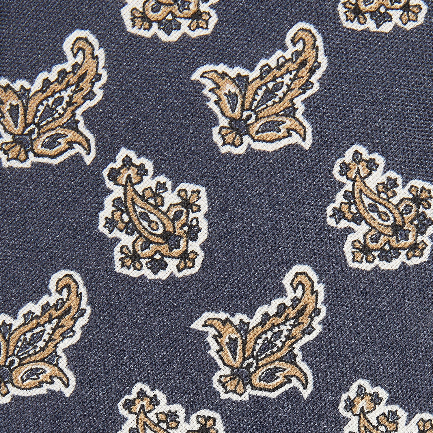View 2 of product The Turnbull & Asser Navy Paisley Floral Cotton Silk Blend Tie features beige and light blue paisley motifs on navy, with one end rolled.