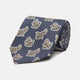 The Turnbull & Asser Navy Paisley Floral Cotton Silk Blend Tie features beige and light blue paisley motifs on navy, with one end rolled.