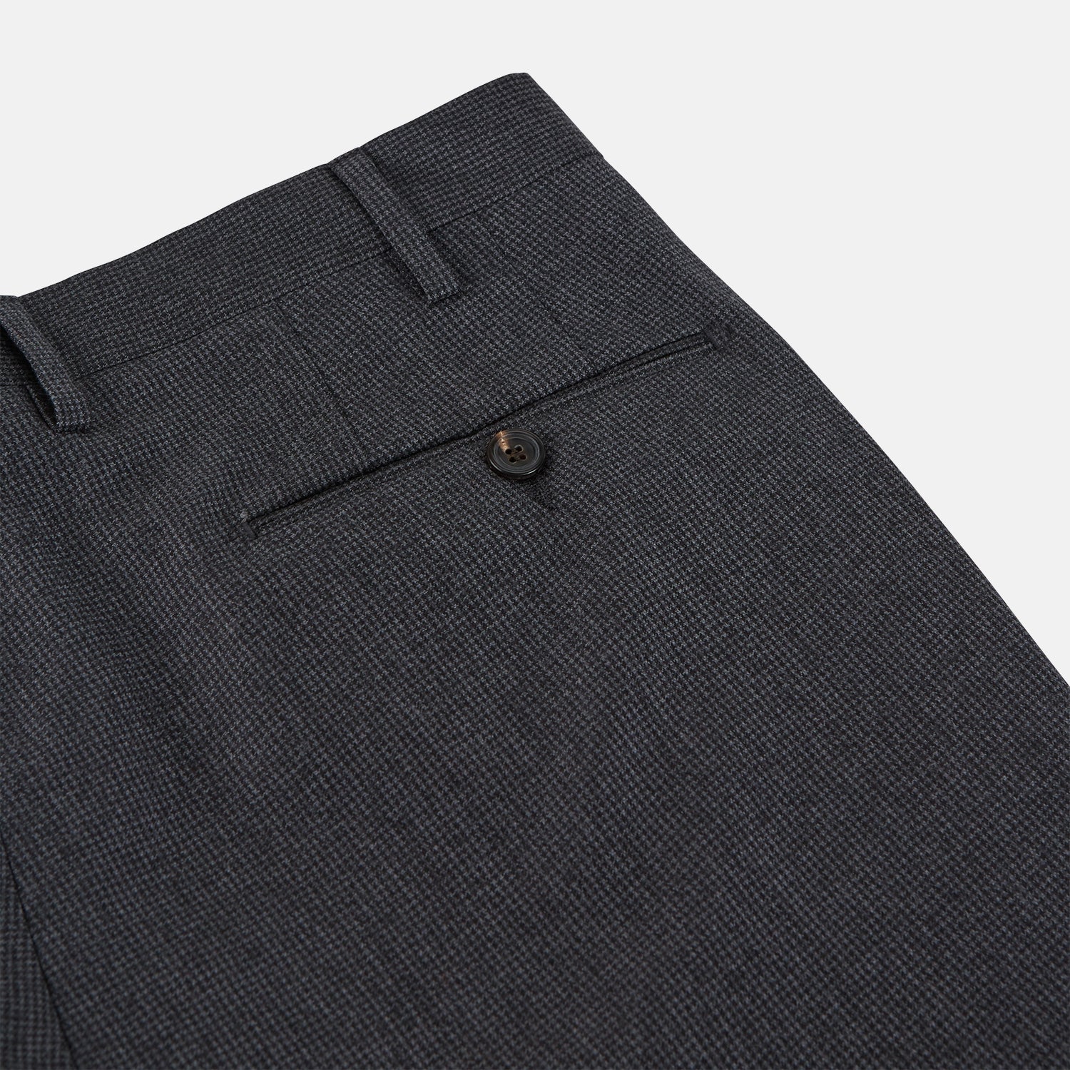 View 3 of product Turnbull & Asser Charcoal Houndstooth Flannel Trousers with a straight-leg cut, front zipper, button closure, belt loops, and side pockets, shown laid flat on a white background.